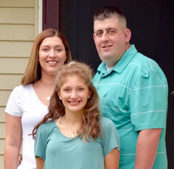Bryan Heath and his family standing outside of their new West Michigan home